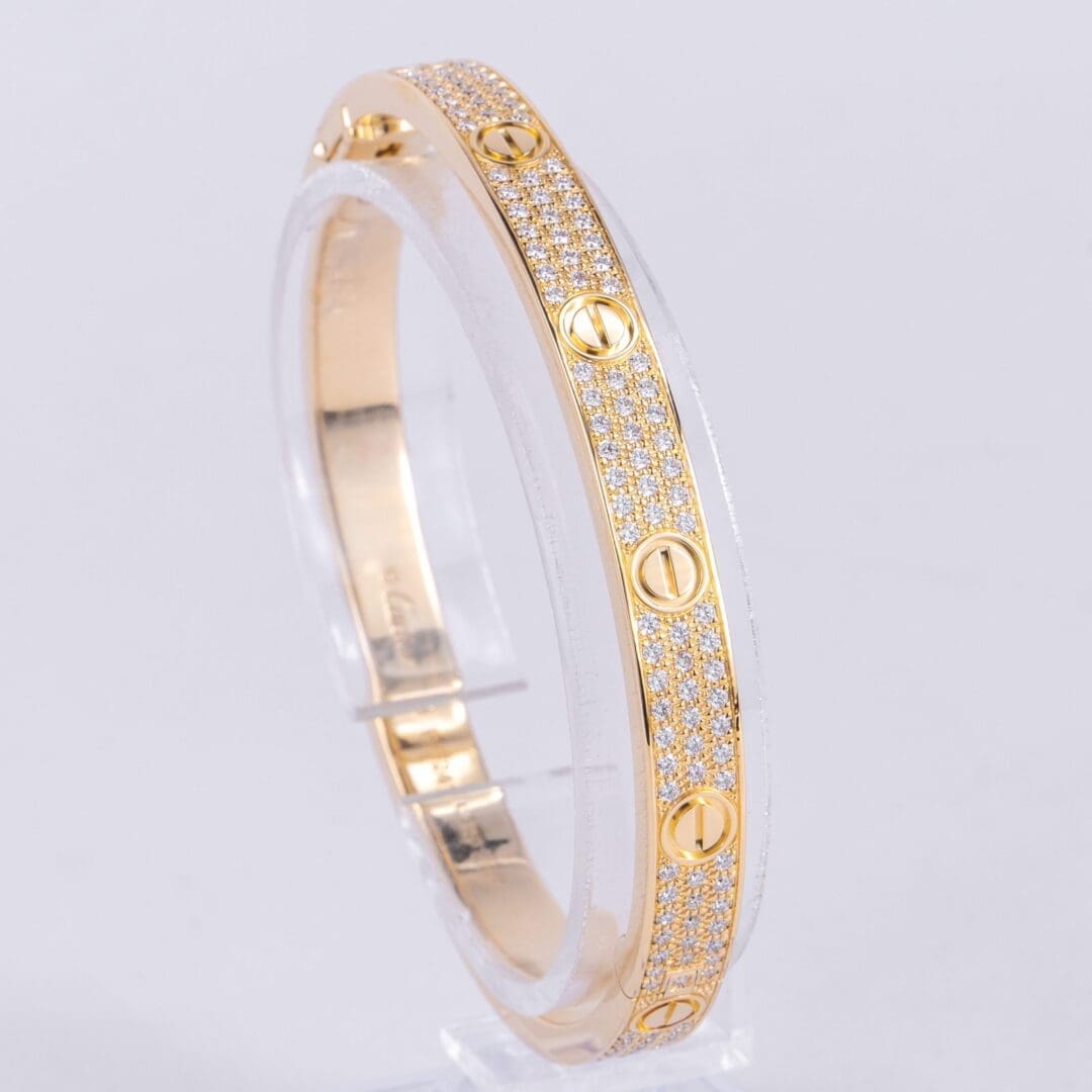 Gold bracelet with diamond accents on display.
