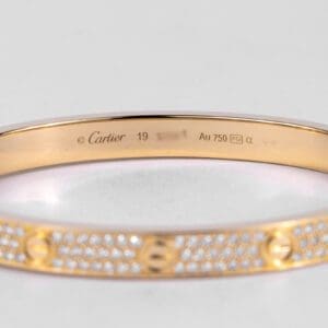 Gold Cartier bracelet with diamond accents.