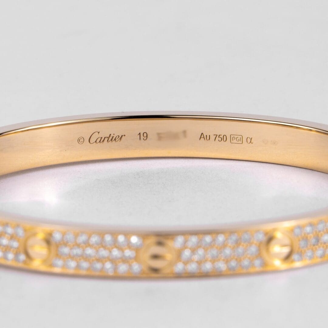 Gold Cartier bracelet with diamond accents.