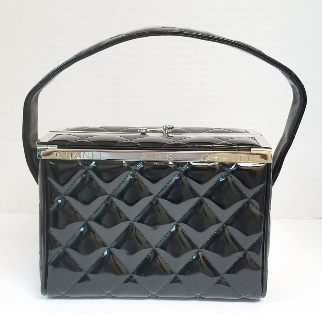 Black quilted handbag with a single handle.