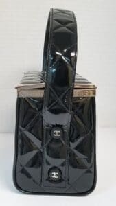 Black quilted handbag with shiny finish.