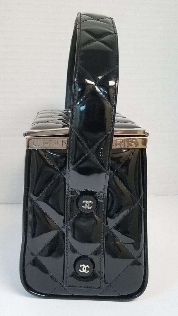 Black quilted handbag with shiny finish.