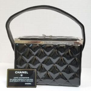 Black quilted handbag with authenticity card.