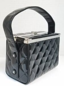 Black quilted handbag with silver accents.