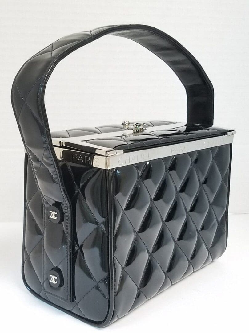 Black quilted handbag with silver accents.