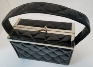 Quilted black handbag with a metal clasp.