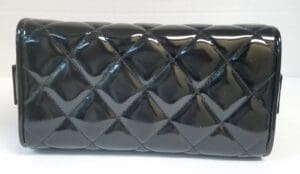 Black quilted clutch purse on display.