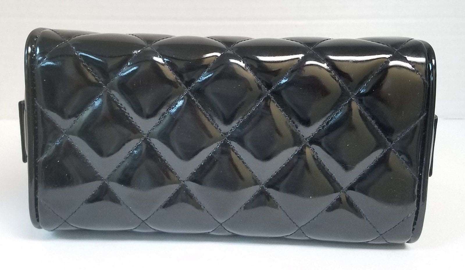 Black quilted clutch purse on display.