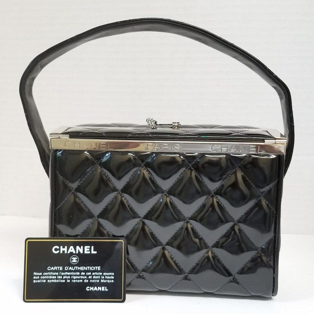 Black quilted handbag with authenticity card.