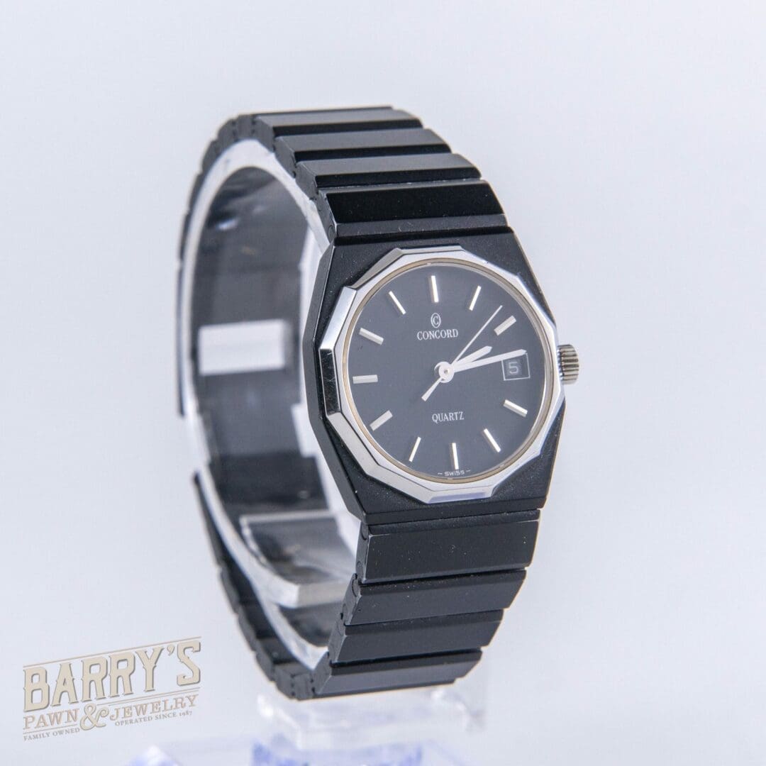 Black wristwatch with date display, octagonal case.