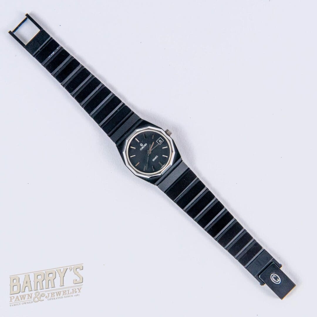 Black wristwatch with metal bracelet.
