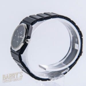 Black wristwatch displayed on transparent stand.