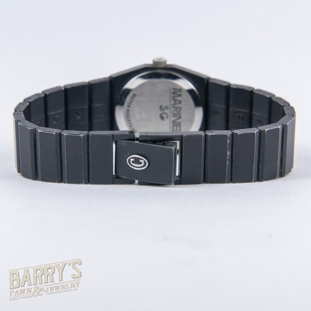 Black wristwatch with metal band, back view.