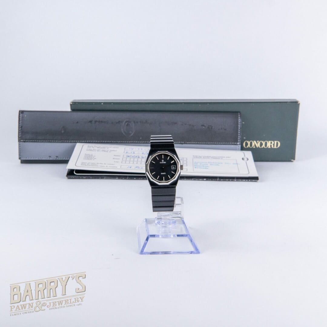 Black Concord watch with box and documents.