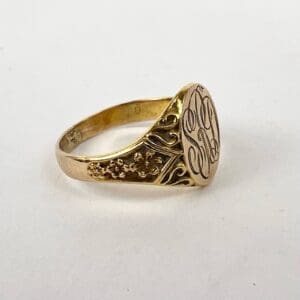 Gold ring with intricate engraved design.
