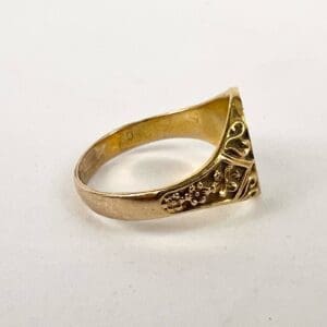 Gold ring with floral engraved design.