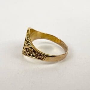 Gold ring with engraved floral design.