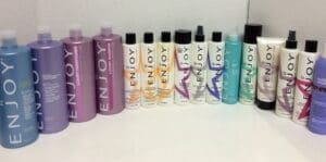 Various Enjoy hair care product bottles arranged.