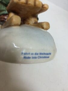 Figurine base with "Ride into Christmas" text.