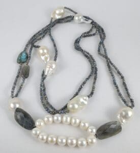 Pearl and gemstone necklace with dark beads.