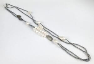 Beaded necklace with pearls and gray stones.
