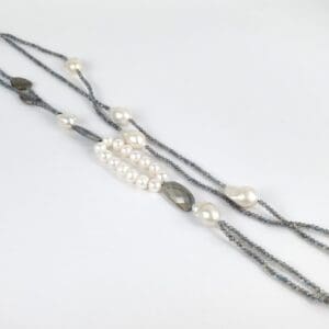 Beaded necklace with pearls and gray stones.