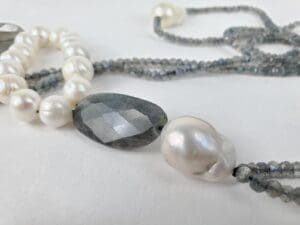 Pearl and gemstone necklaces on display.