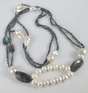 Pearl and gemstone beaded necklace on display.