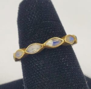 Gold ring with blue gemstone accents.