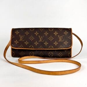 Brown designer handbag with monogrammed pattern.