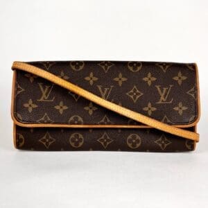 Brown designer clutch with monogram pattern.