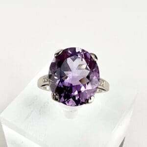 Silver ring with large purple gemstone.
