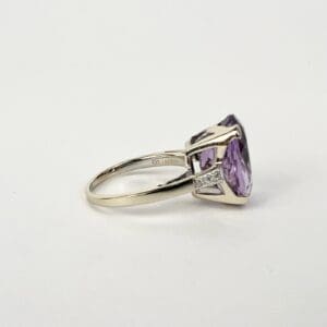 Silver ring with large purple gemstone.