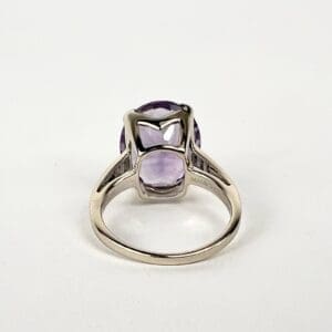 Silver ring with a purple gemstone.