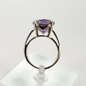 Silver ring with a purple gemstone.