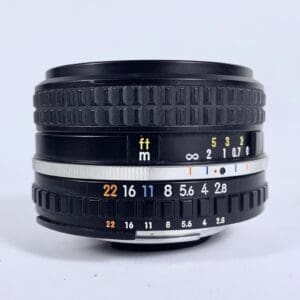 Black camera lens with focus and aperture markings.