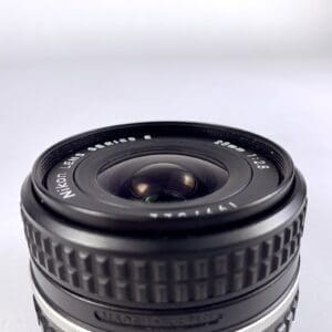 Close-up of Nikon camera lens, 28mm f/2.8.