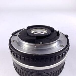 Camera lens bottom view on white background.