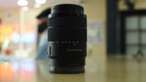 Camera lens on a blurred background surface.