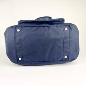 Blue bag bottom with metal studs.