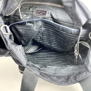 Open Prada bag with visible lining.
