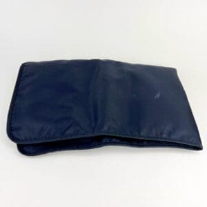 Dark blue folded cloth on white background.