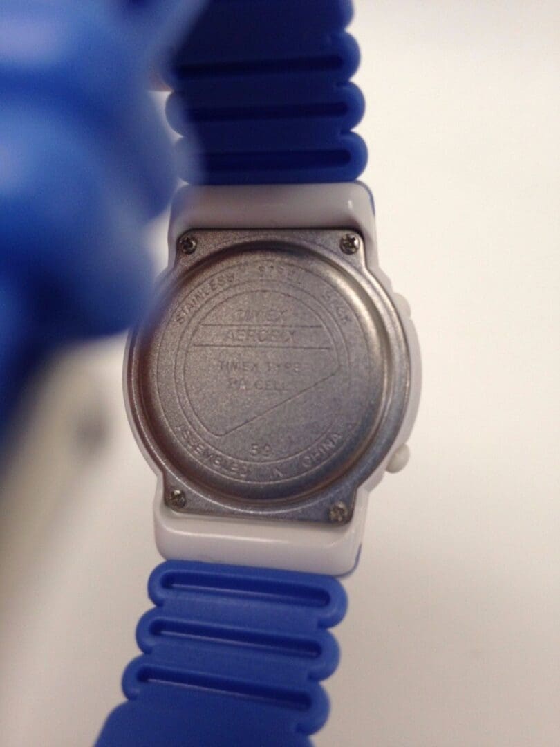 Back of watch with blue strap.