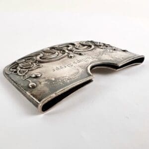 Ornate silver card holder with floral design.