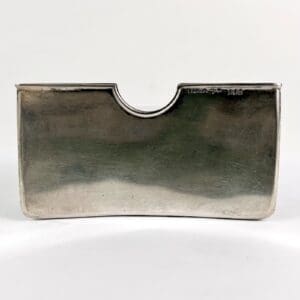 Silver card holder with rounded top edge.