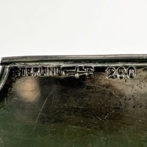 Sterling silver item with engraved markings.