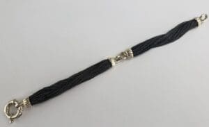 Black and silver bracelet with clasp.