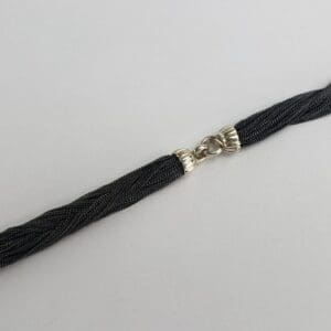 Black and silver bracelet with clasp.