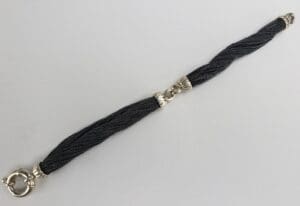 Black twisted bracelet with silver clasps.