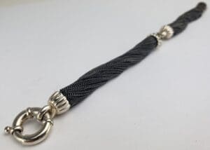 Black woven bracelet with silver clasp.
